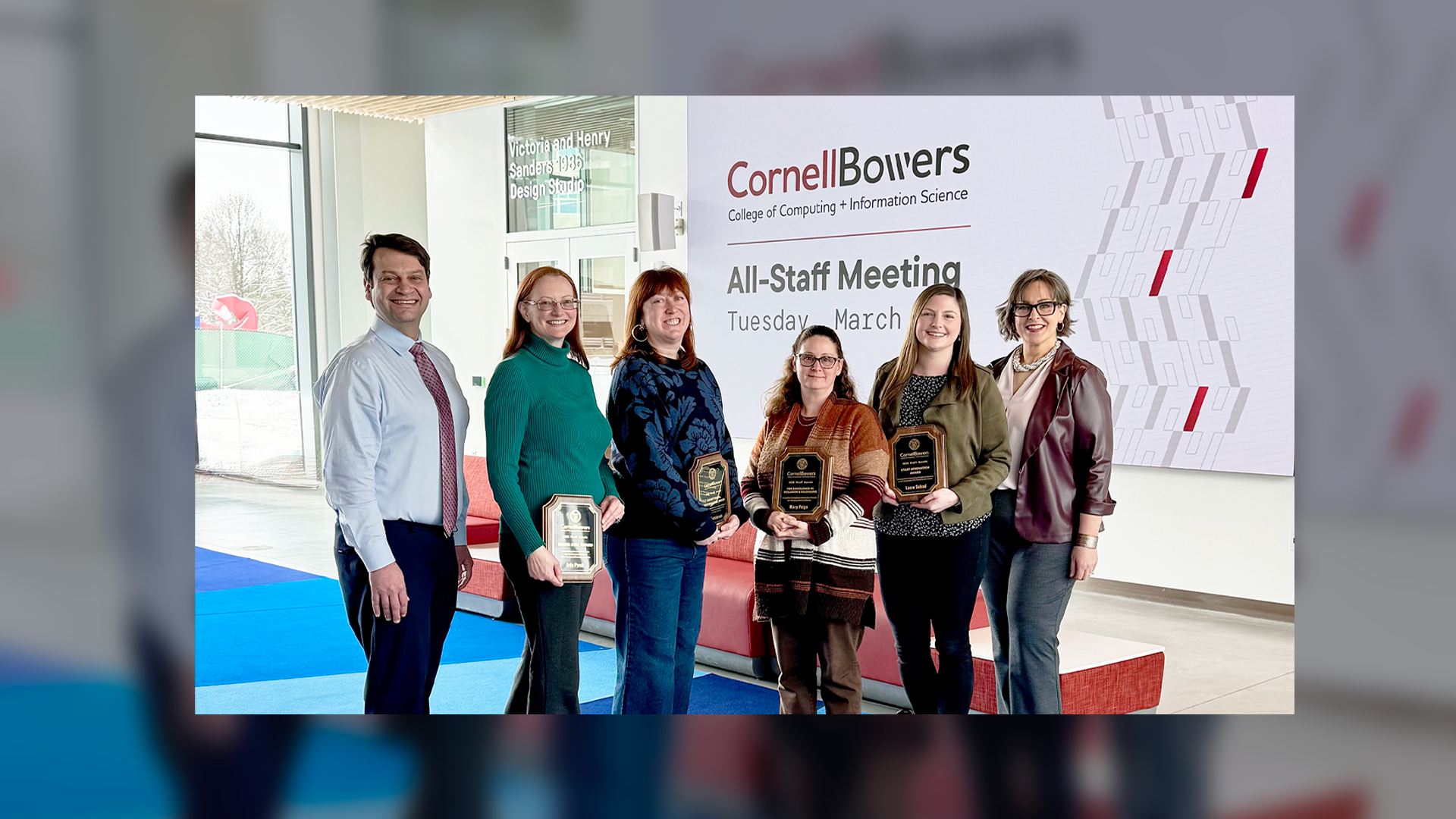 A color photo showing staff award winners and presenters.