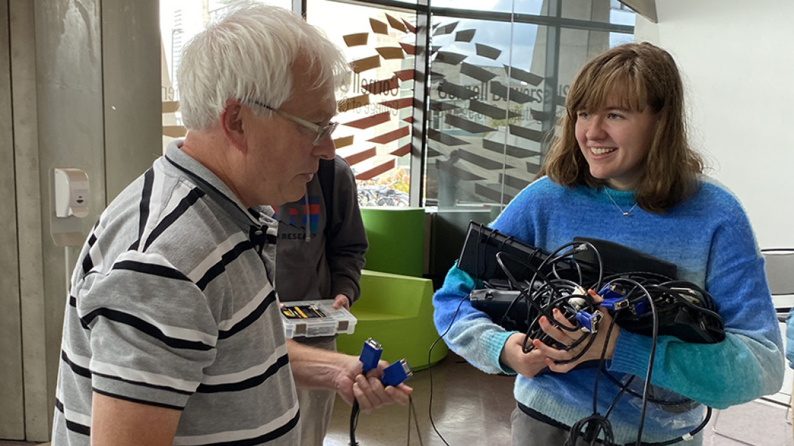 A color photo showing 2 people at Bowers Repair Fair.