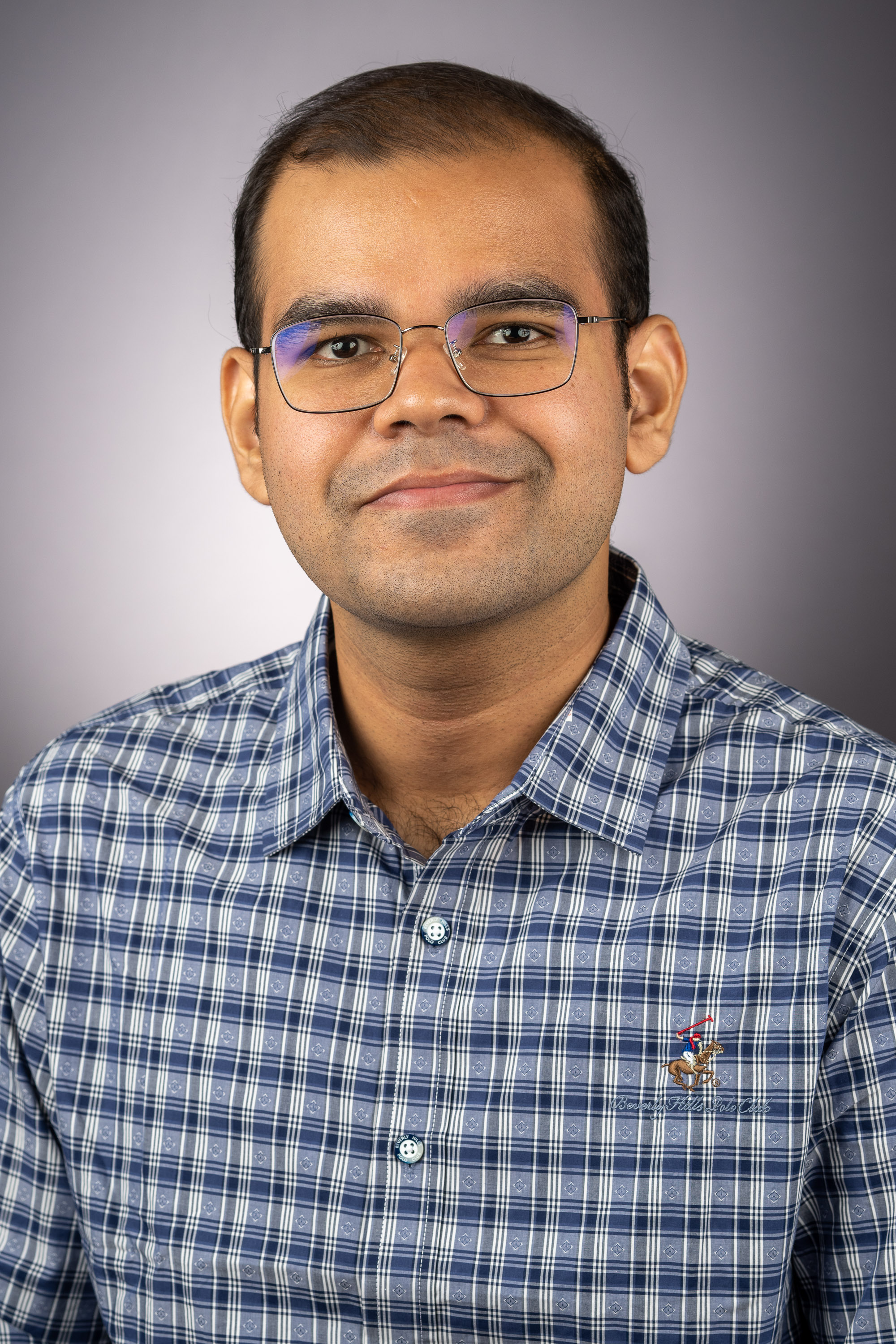 A color photo of a man smiling for a photo