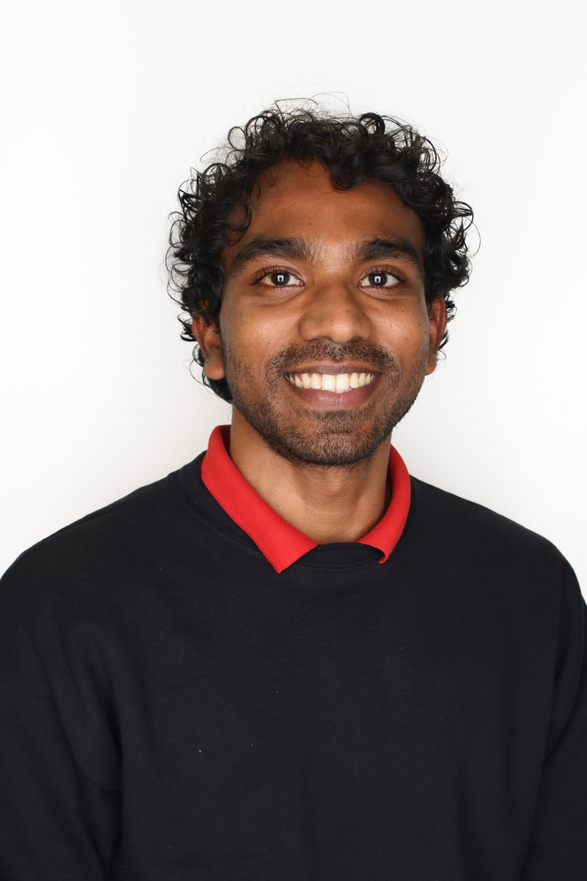 A color photo of a man smiling for a photo