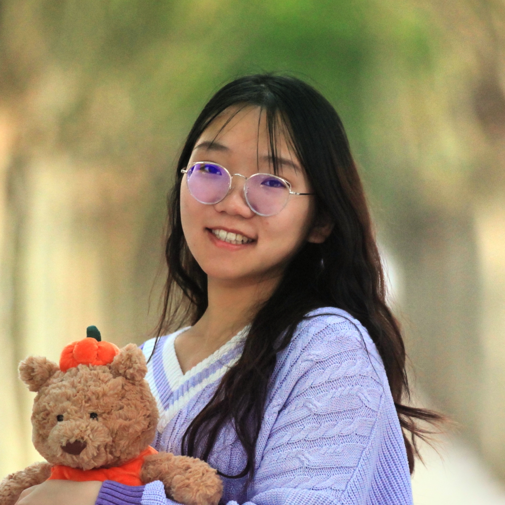 A color photo of a woman smiling for a photo