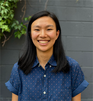 A color photo of a woman smiling for a photo