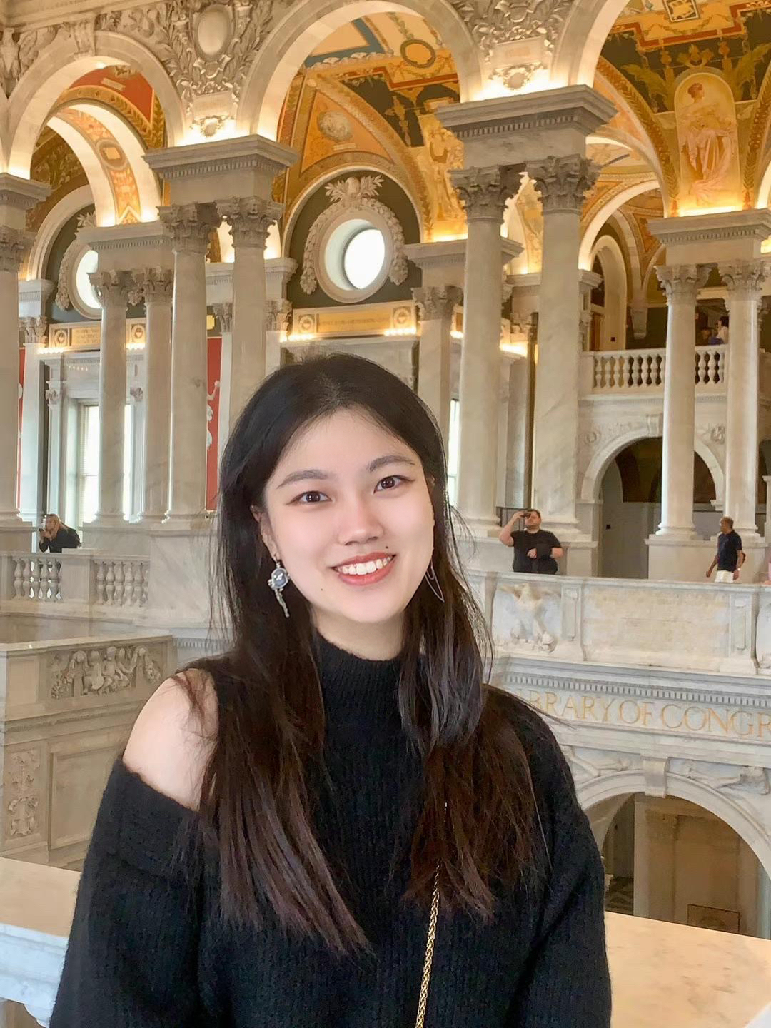 A color photo of a woman smiling for a photo