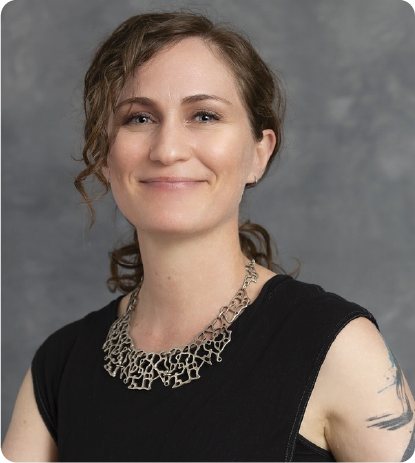 A color photo of a woman smiling for a portrait.