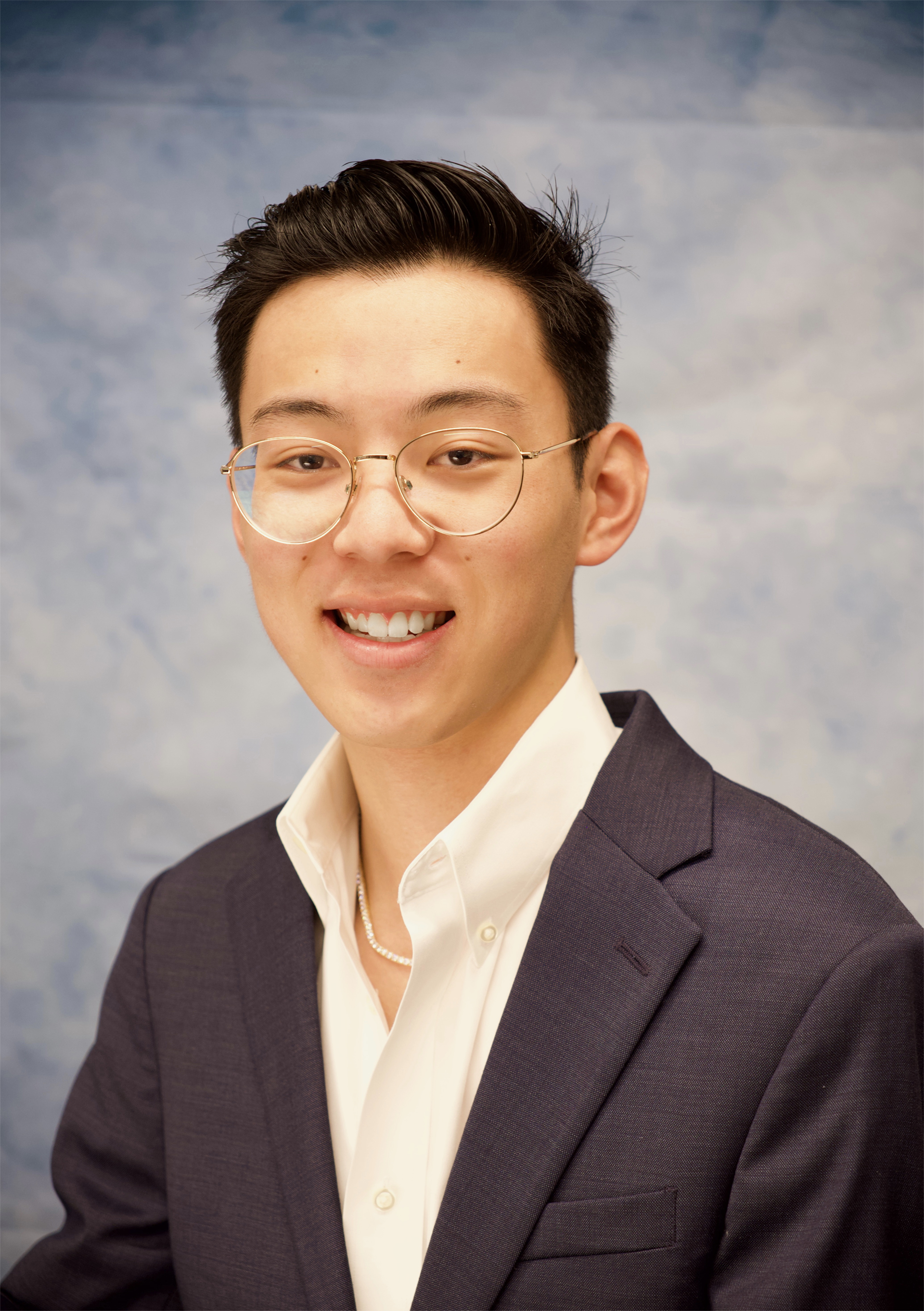 A color photo of a man smiling for a photo