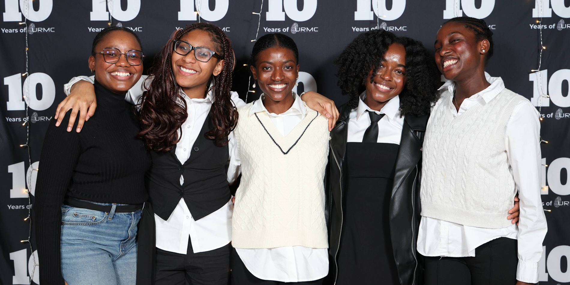 A color photo showing a group of women smiling for a photo.