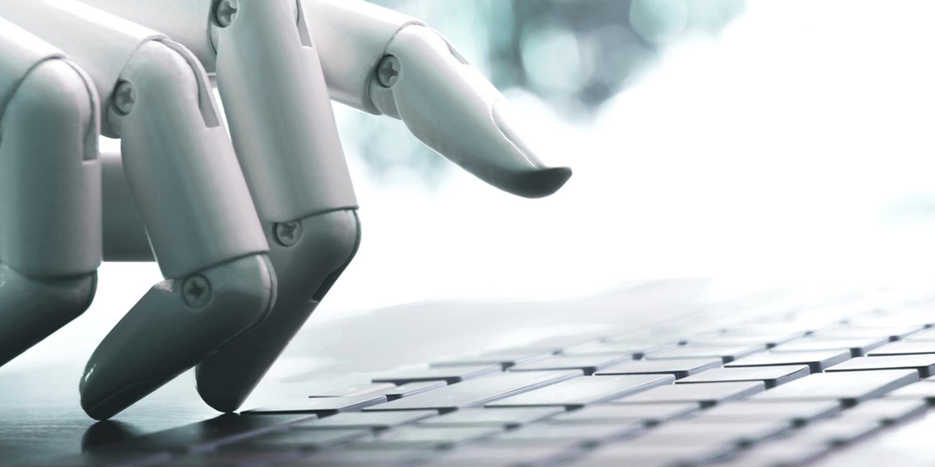 A white robotic hand types on a keyboard