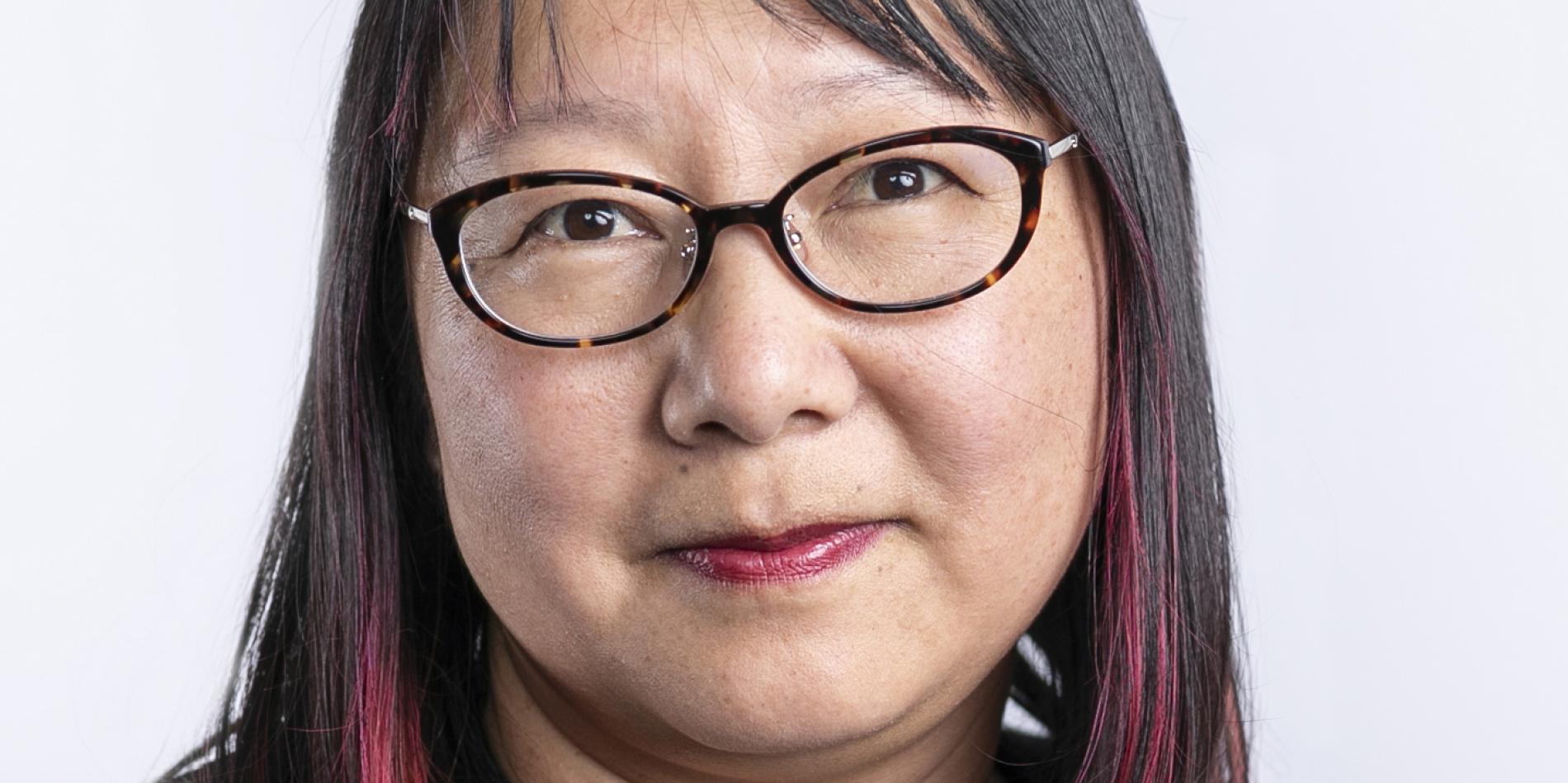 portrait of woman with medium length dark hair and glasses