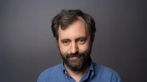 A color photo of man with beard and dark hair