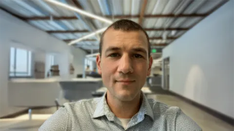 A photo of Nate Foster, a man with short brown hair and a gray shirt.
