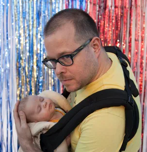 Photo of Chris Csíkszentmihályi holding his baby