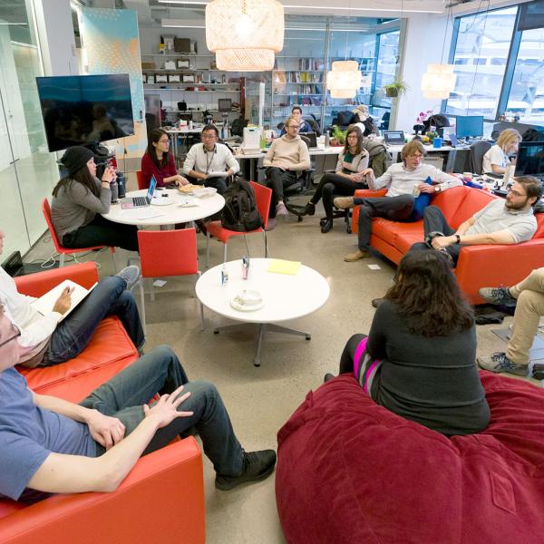 Group of students and faculty having a discussion in a collaborative workspace.