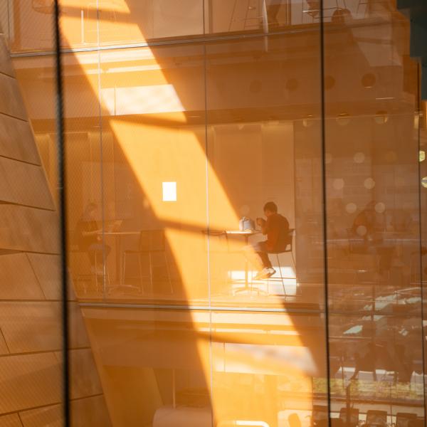 orange colored walls and glass panes reflect light in Gates Hall interior walls