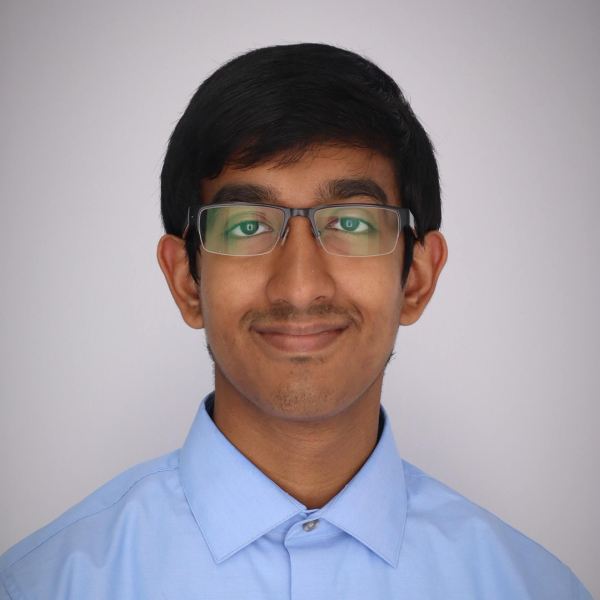 A color photo of a man smiling for a photo.