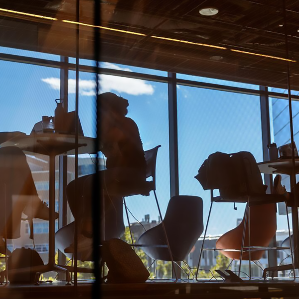 A color photo showing students working in a lounge area.
