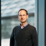 David Mimno stands in front of a window at Gates Gall