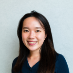 A color photo of a woman smiling for a photo.