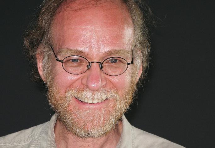A photo of Joseph Halpern, a man with light brown-white hair, glasses and a beige shirt