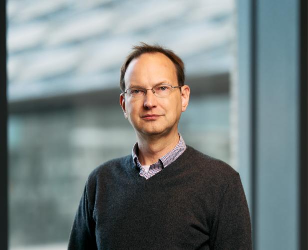 David Mimno stands in front of a window at Gates Gall