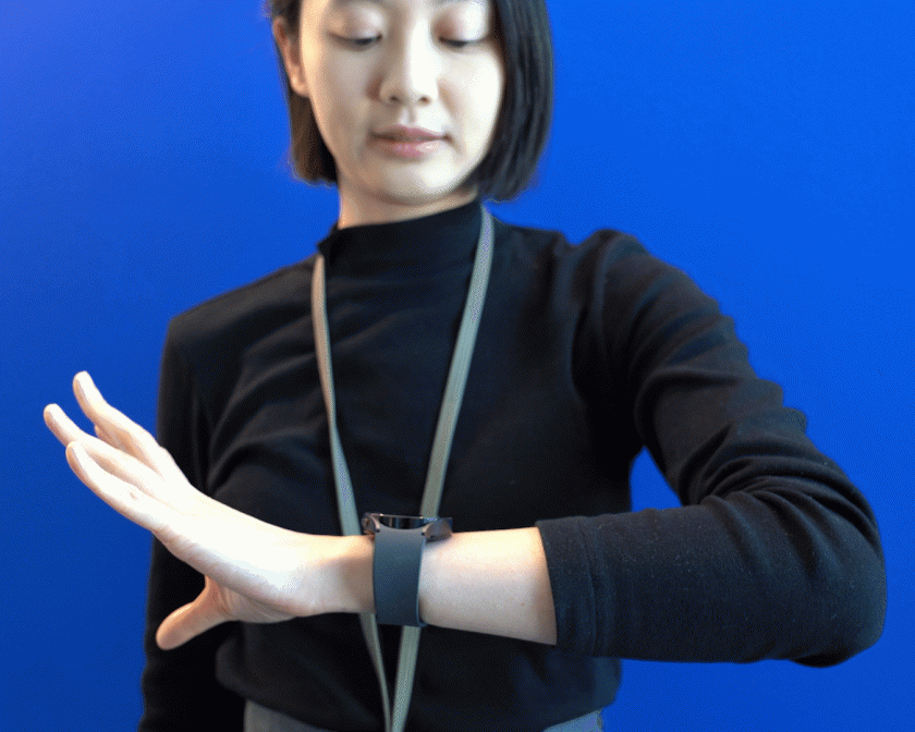 An animated gif of a video showing a woman moving her hand while looking at a smartwatch