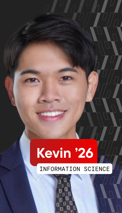 a young Asian man with black hair smiles in front of a black background