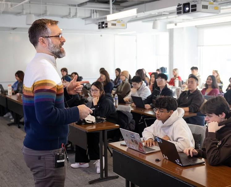 Professor teaching to a classroom fill of students.