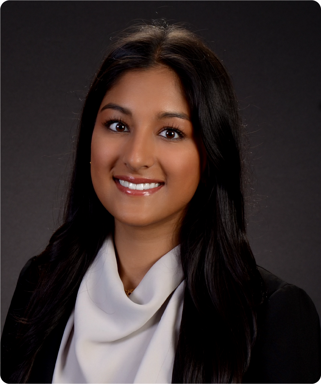 A color photo of a woman smiling for a photo.