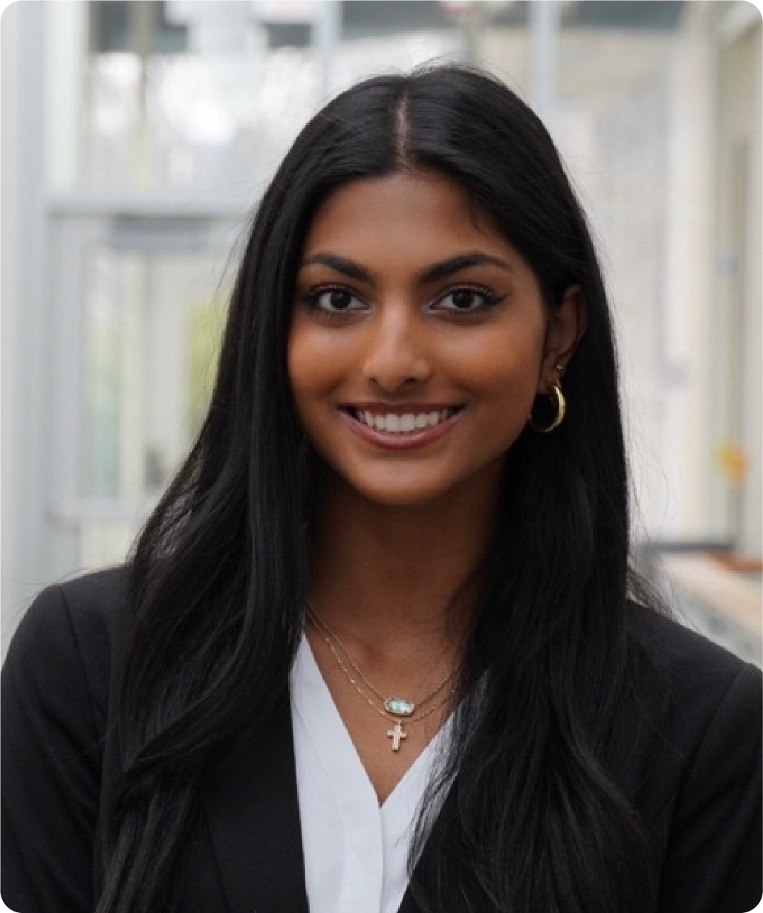A color photo of a woman smiling for a photo.